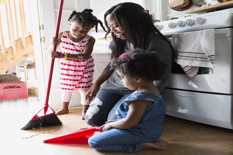 Mother and Children Doing Chores Together